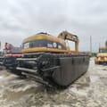2021 Caterpillar 320C amphibious excavator, rear three-quarter view