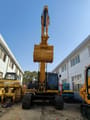 Caterpillar 336D crawler excavator, front view with boom raised