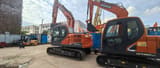 2023 Doosan DX140 excavator, side view