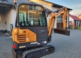 2022 CASE CX19C Mini Excavator showing the side of the cab and the orange engine cover with visible vents.