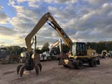 2012 Caterpillar M318 MH wheel excavator, front three-quarter view
