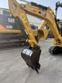 2022 Caterpillar 301.7 Mini Excavator close-up of the boom, arm, and black digging bucket.