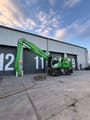 2022 Sennebogen 821 E Material Handler with its bright green boom extended forward