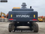 2025 Hyundai R340L Crawler Excavator from the rear, emphasizing the wide dark gray tracks and undercarriage.