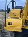 2025 Komatsu PC225LC-11MO Crawler Excavator showing a close-up of the yellow machine body with steps and handrails.