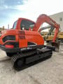2023 Doosan DX75-9C mini excavator, rear three-quarter view