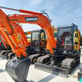 2024 Doosan DH55 mini excavator, front three-quarter view