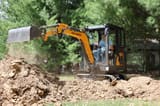 2025 APS KME20 Mini Excavator with an operator in the cab, actively digging with the bucket.