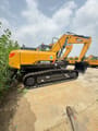 2025 Sany SY215H Crawler Excavator with its main body and boom in yellow, viewed from the rear right, highlighting the counterweight and