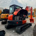2023 Kubota KX165 mini excavator, front three-quarter view with engine cover open