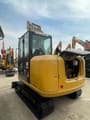 2024 Caterpillar 305.5E2 mini excavator, rear three-quarter view