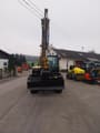 Caterpillar 306CR-07A mini excavator, front view with boom raised