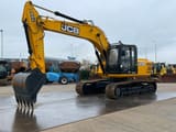 2025 JCB 205 Crawler Excavator with a black digging bucket and the boom angled to the left.