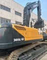2024 Hyundai 305LVS crawler excavator, rear three-quarter view