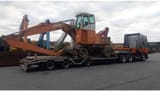 1998 Atlas 1704 MI material handler on a flatbed trailer