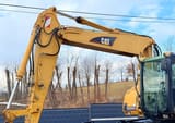 2003 Caterpillar M315C wheel excavator boom and cab side view