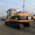 2022 Caterpillar 320C excavator, rear three-quarter view