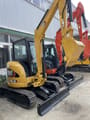 2024 Caterpillar 303.5E mini excavator, rear three-quarter view