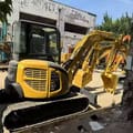2023 Komatsu PC-55MR mini excavator, rear three-quarter view
