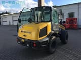 2021 New Holland W50C mini excavator, rear three-quarter view