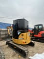 2024 Caterpillar 303.5E mini excavator, rear three-quarter view