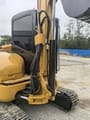 2023 Caterpillar 303.5E mini excavator side view of cab and boom