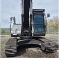 2026 Zoomlion ZE210GLC Crawler Excavator with a light grey body, showing the robust black tracks and undercarriage from the front.