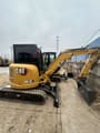 2024 Caterpillar 303.5E mini excavator, rear three-quarter view