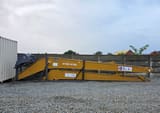2025 Caterpillar CAT Crawler Excavator long reach boom and arm components with an attached bucket, viewed from the side.