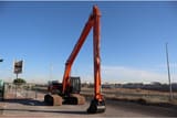 2025 Tata Hitachi EX215LC Crawler Excavator with its long reach boom and arm fully extended, showcasing the 'SUPER LONG REACH' decal.