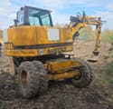 2002 Hydrema M800 wheel excavator, rear three-quarter view