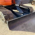 Hitachi ZX75US crawler excavator, front view of blade and tracks