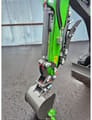 2026 WCM CTX8010 Mini Excavator showing the bucket and quick coupler mechanism on the bright green arm.
