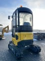 2024 NEX N18 Mini Excavator from the front, highlighting the dozer blade and the front of the tracks.