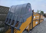 2025 Caterpillar CAT Crawler Excavator grey digging bucket with visible teeth and a red and blue logo.