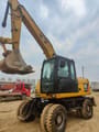 2023 Caterpillar 315D wheel excavator, front three-quarter view