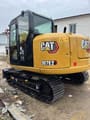 2024 Caterpillar 307E2 excavator, rear three-quarter view
