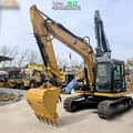 2022 Caterpillar 313D2 GC crawler excavator, front three-quarter view