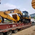 2016 Caterpillar 325D crawler excavator, side profile view on flatbed trailer