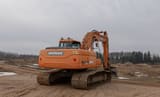 Doosan DX225LC crawler excavator, rear three-quarter view