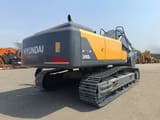 2025 Hyundai R340 Crawler Excavator showcasing its robust dark grey tracks and undercarriage.