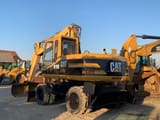 2000 Caterpillar M315 wheel excavator rear three-quarter view