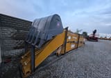 2025 Caterpillar CAT Crawler Excavator long reach boom and arm components with a grey bucket, viewed from a wider angle.