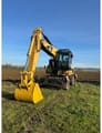 2009 Caterpillar M322D wheel excavator, front three-quarter view