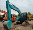 Kobelco SK140-8 crawler excavator, front three-quarter view