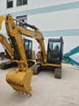2022 Caterpillar 305.5E2 crawler excavator, front three-quarter view