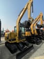 2024 Caterpillar 305.5E2 mini excavator, rear three-quarter view