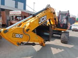 2025 JCB JS200 Crawler Excavator with its bright yellow boom and arm extended forward, showcasing the hydraulic cylinders and black bucket.