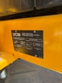 2025 JCB 225 Crawler Excavator with a close-up of the second product identification plate on the yellow body.