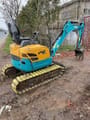 2024 Kubota U15 mini excavator, rear three-quarter view